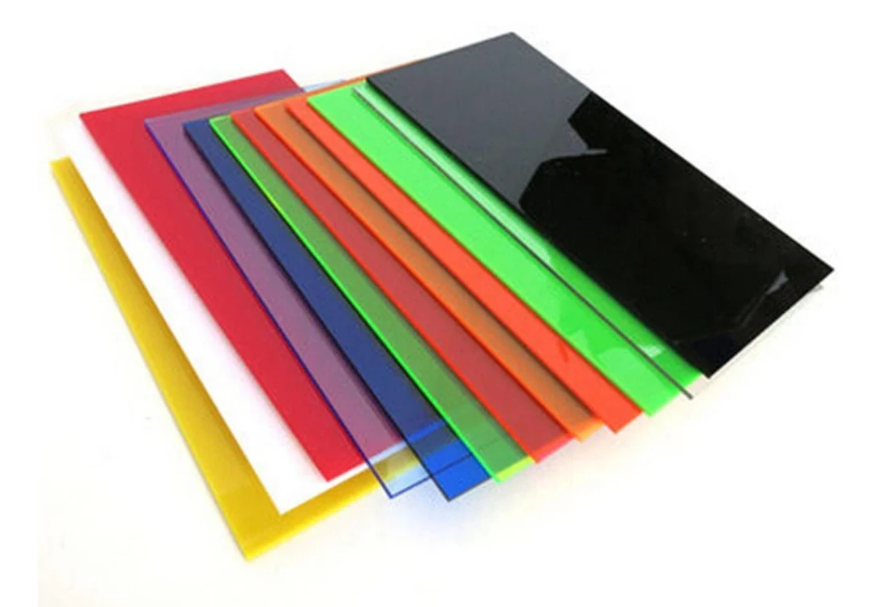 Clear and colored acrylic glass sheets stacked, showing transparent PMMA panels used for construction and signage